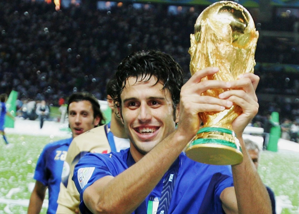 BERLIN - JULY 09: Fabio Grosso of Italy holds the World Cup trophy aloft following his team's victory in a penalty shootout at the end of the FIFA World Cup Germany 2006 Final match between Italy and France at the Olympic Stadium on July 9, 2006 in Berlin, Germany. (Photo by Alex Livesey/Getty Images)